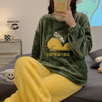Green and Yellow Pajamas with Duck laying on the ground